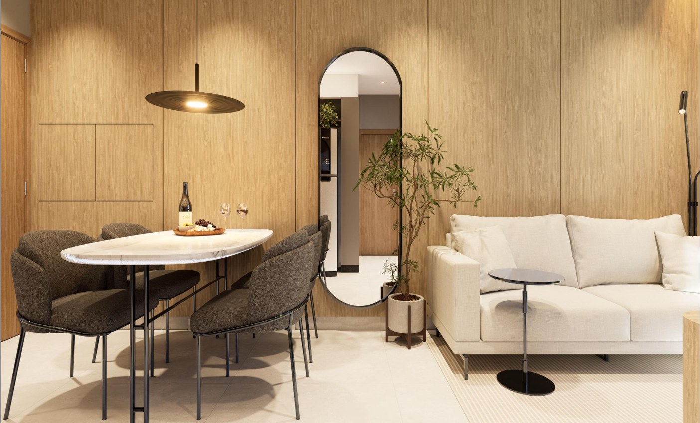 Sala com mesa oval, espelho e sofá